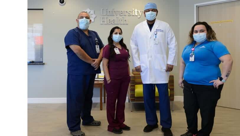 Group of nurses standing with doctor in waiting room