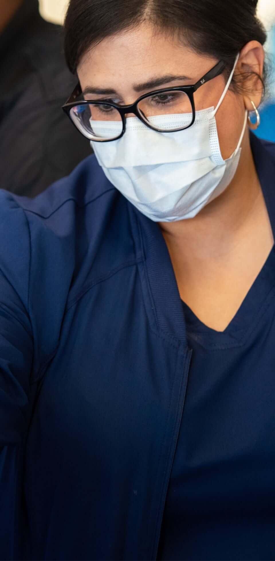 Female nurse looking at something on a screen