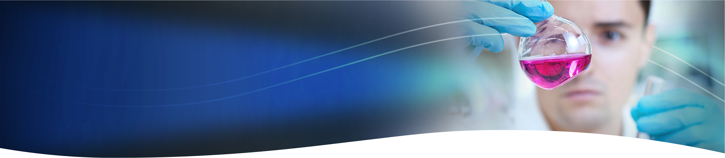 lab scientist looking at a magenta liquid in a glass