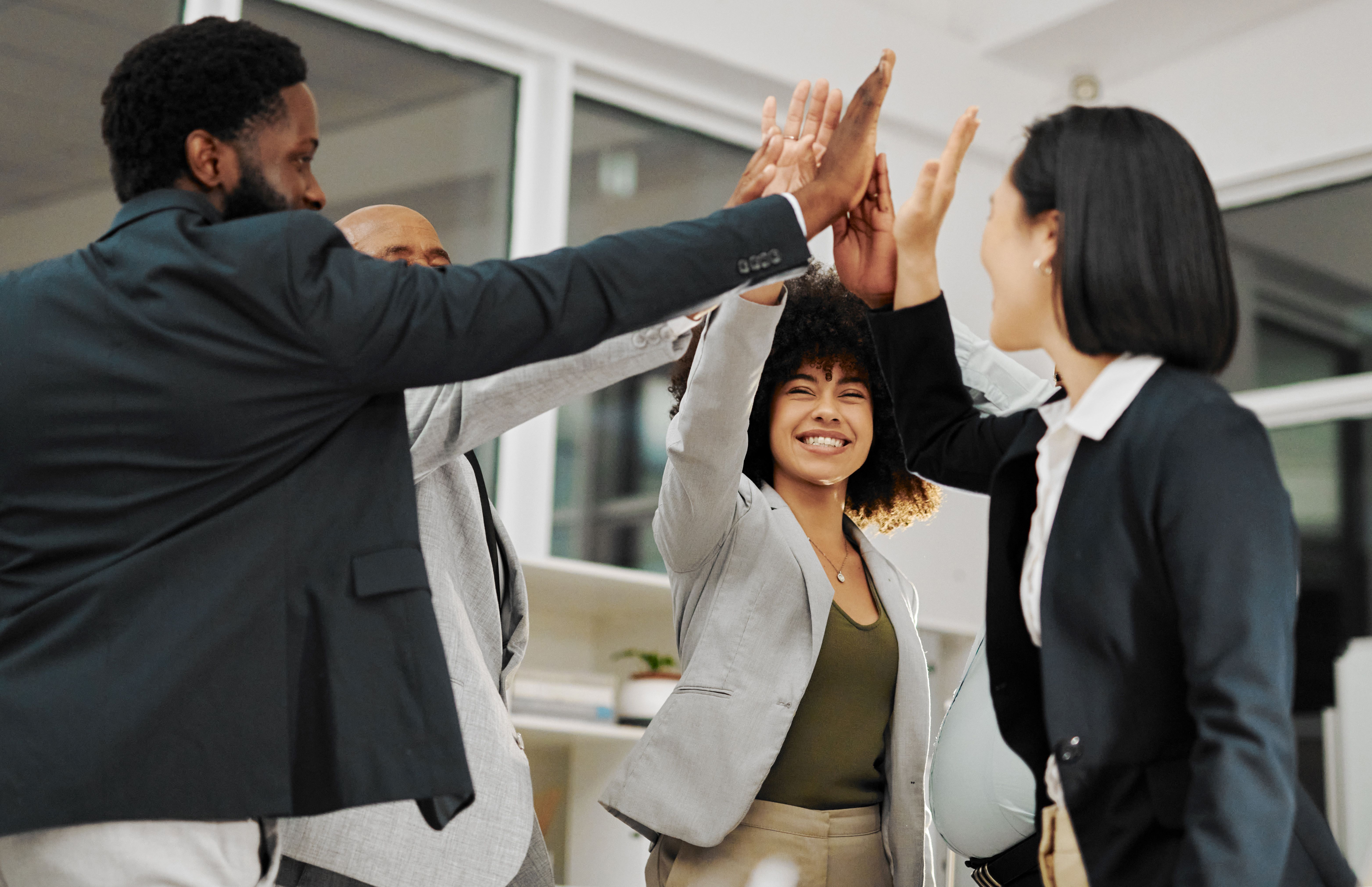 Happy employees high-fiving.