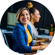Female employee sitting at a table smiling