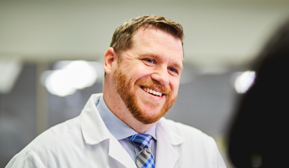 Person in a lab coat smiling