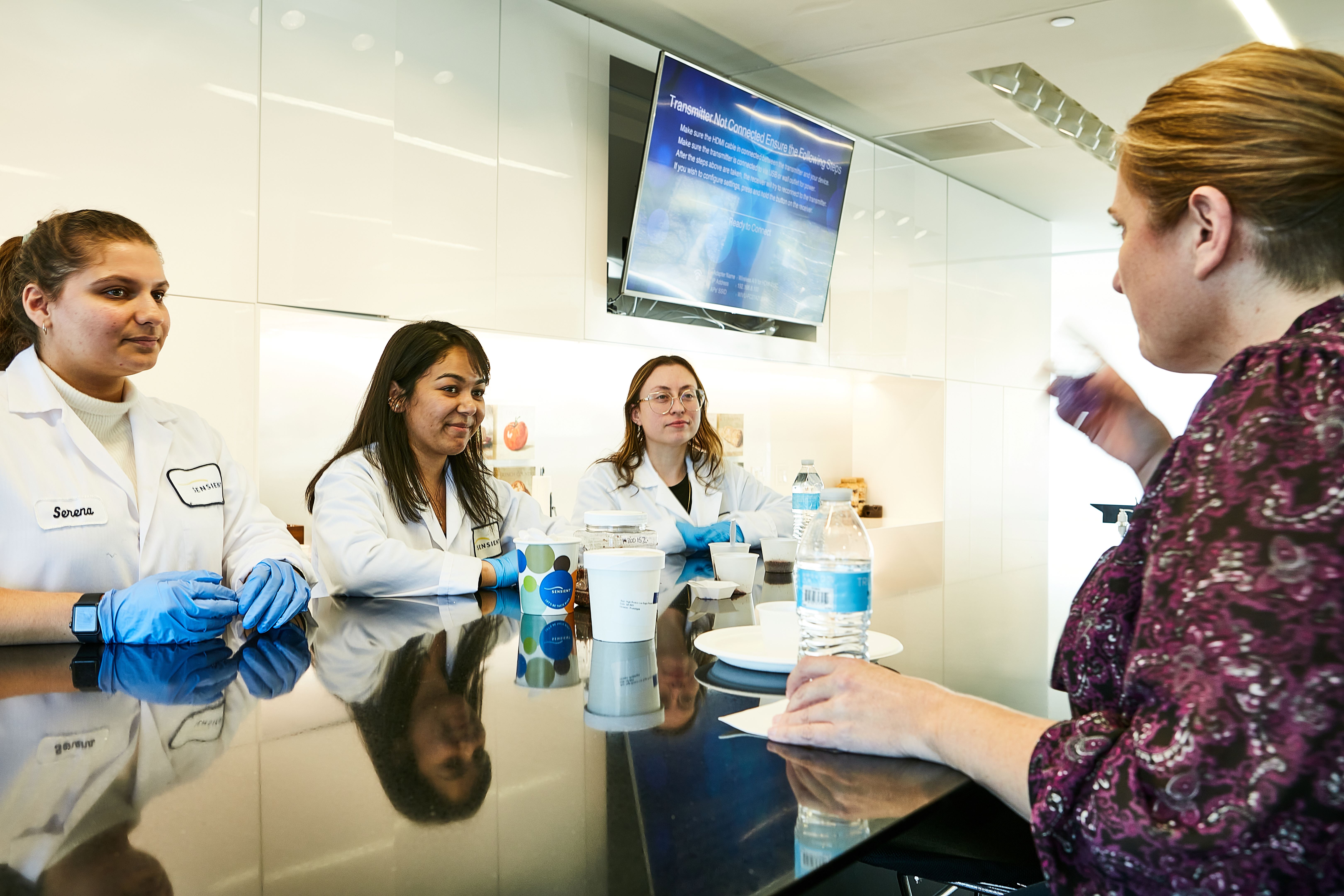 A group of employees presenting a food tasting.