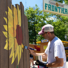 Man painting on a fence