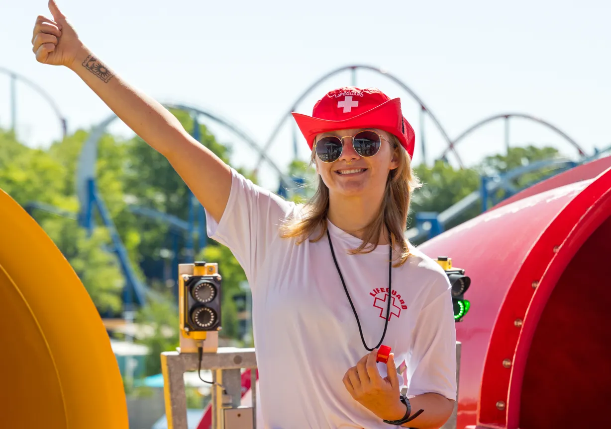Lifeguard giving a thumbs-up at a water park.
