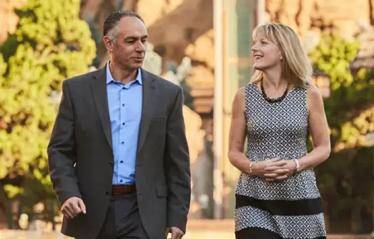 Male and female leader walking together and chatting