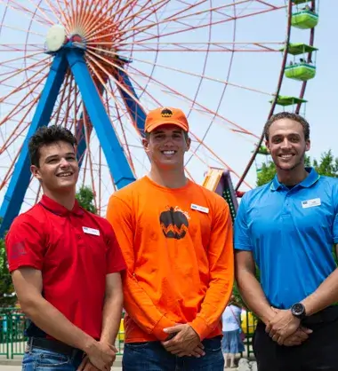 Employees standing in front of a ferris wheel