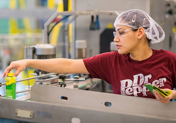 Female employee opening bottle cap