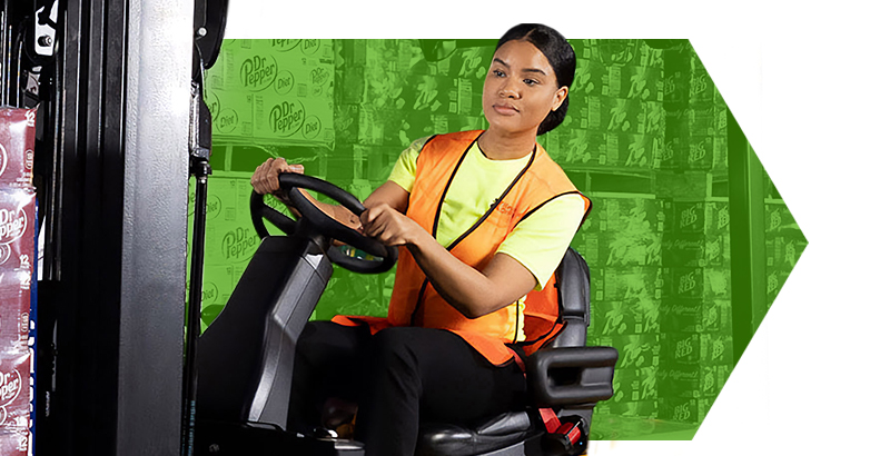 Female employee driving a forklift
