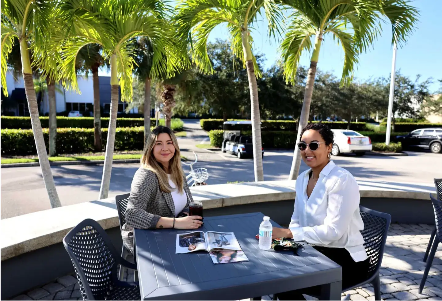 Two Chico's FAS employees sitting in an outside patio.