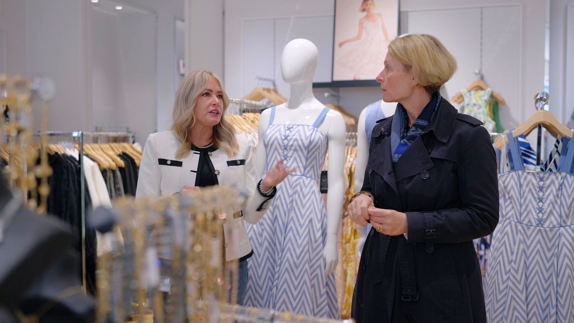 Two women talking in a retail store.