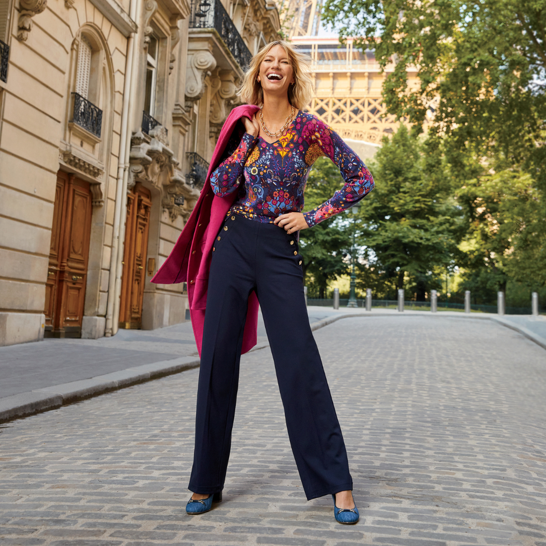 Woman outside with jacket over shoulder.