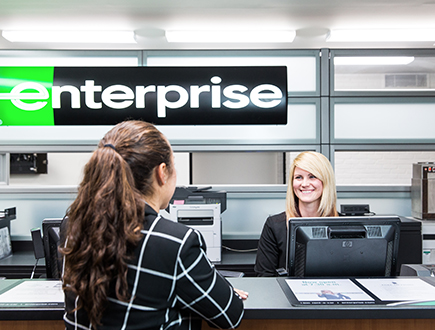 Sara with customer at the Enterprise welcome desk