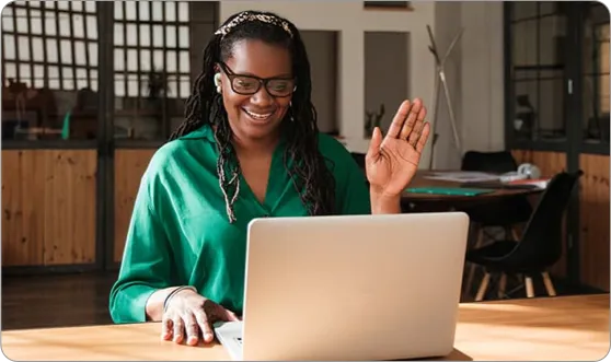 Woman waving on video chat