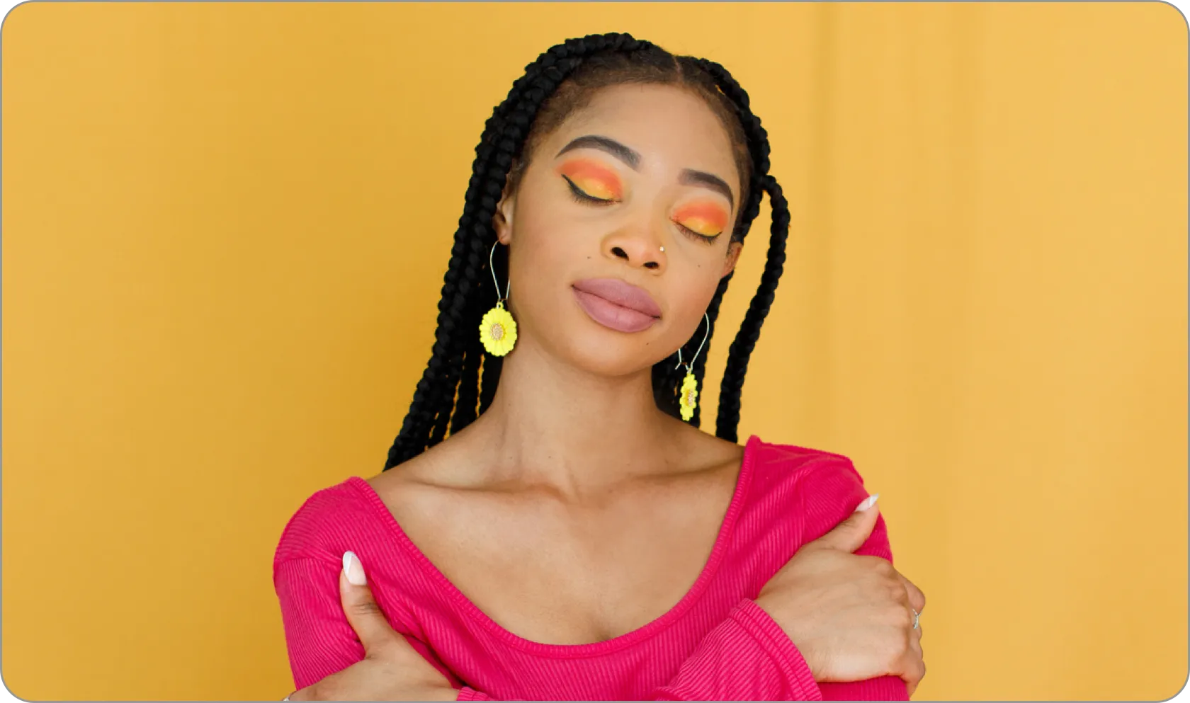 A woman posing in front of a yellow wall
