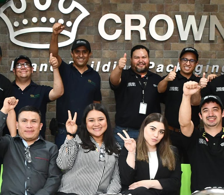 Group of people smiling, cheering and giving a thumbs up