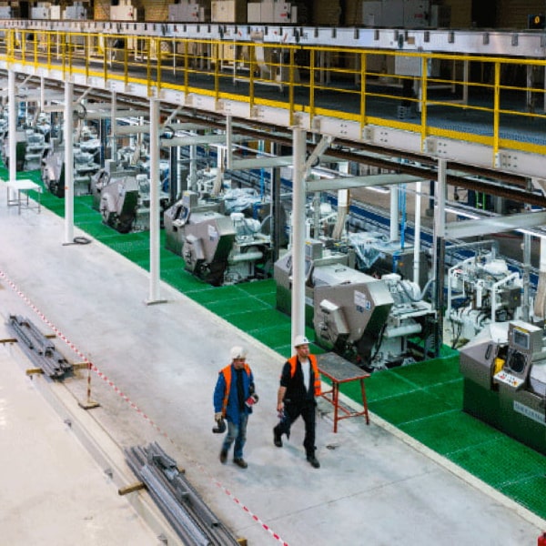 Two men walking in a factory