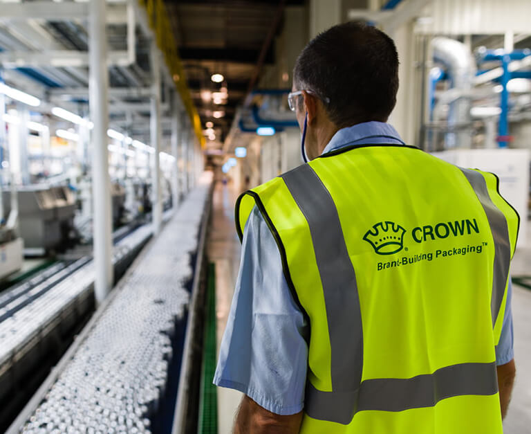 Man in Hi Vis Jacket supervising a manufacturing line