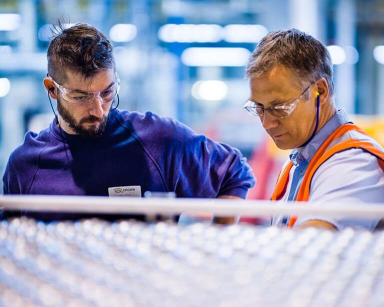 Two men checking work in uniforms