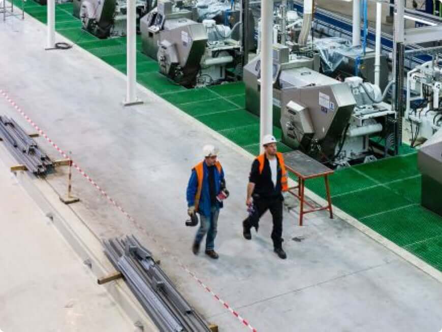 Two men walking in a factory