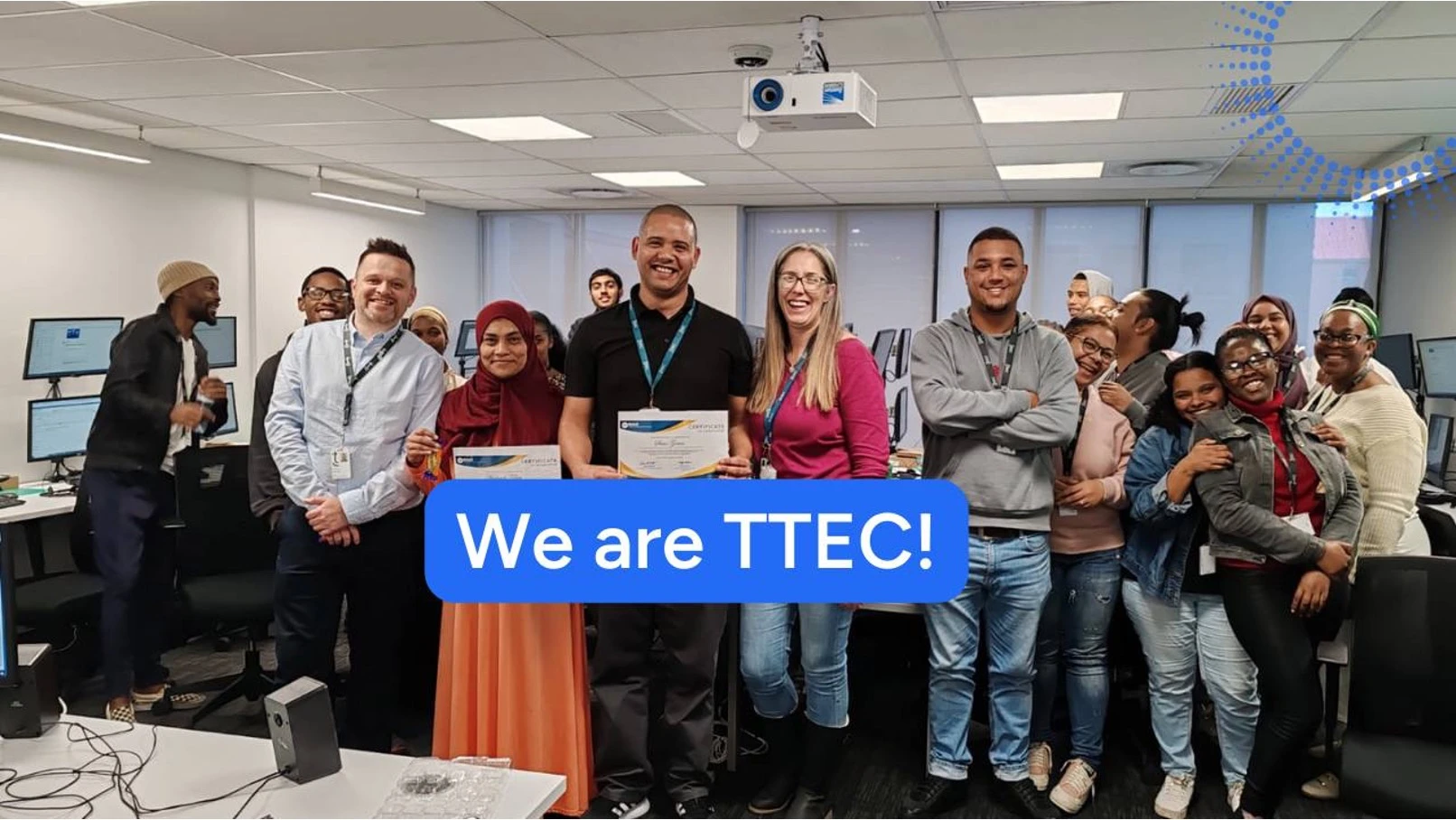 Diverse group of TTEC employees celebrating with certificates.