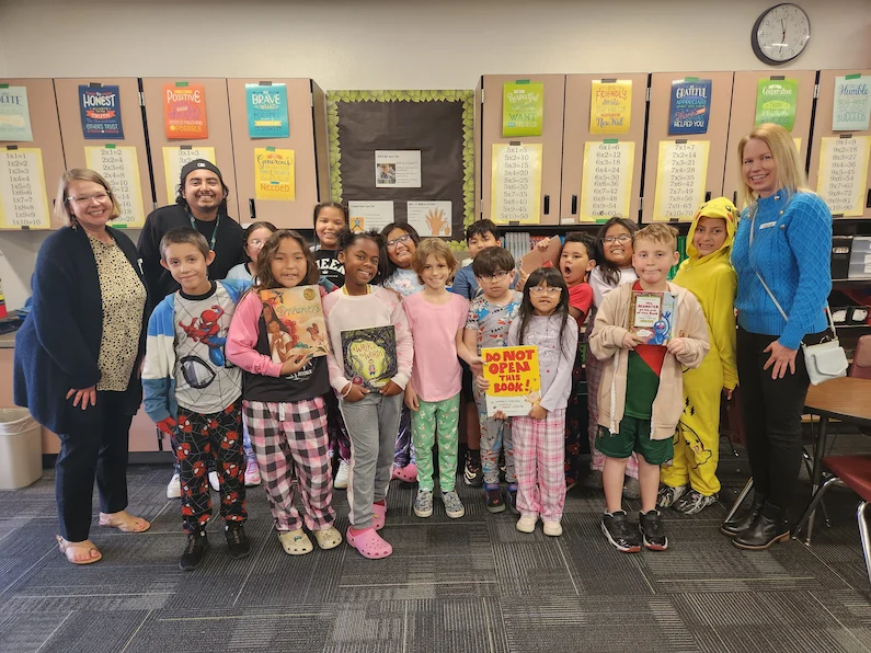 Third-grade students at Osborn School District with their teacher and a volunteer TTEC employee..