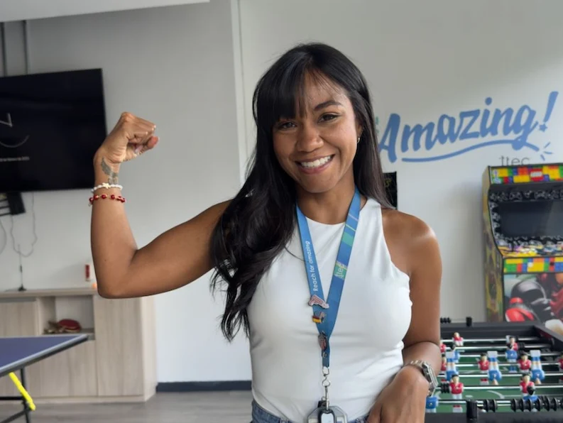 A female TTEC employee smiling for a picture.