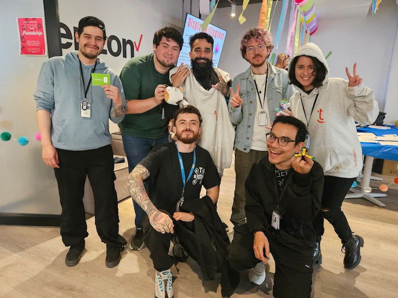TTEC Colombia team members with plushies and company swag.