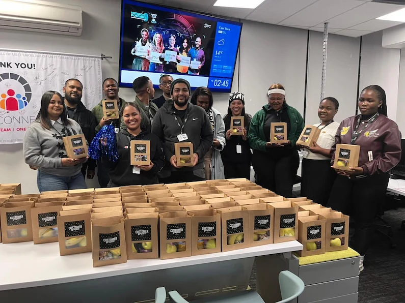 TTEC team in Cape Town South Africa holding treat bags.