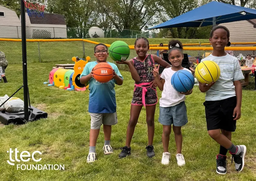 Kids in the Little Legends Daycare smiling happily