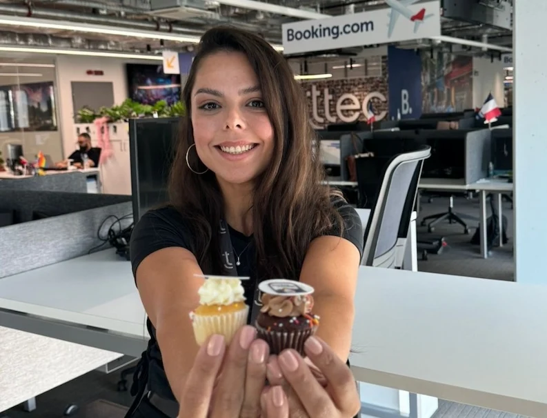 TTEC Athens team member holding cup cakes