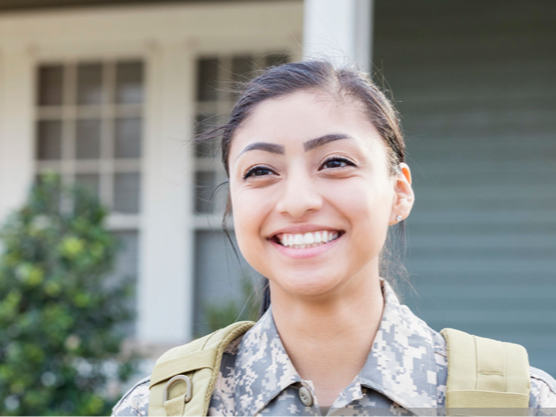 A woman in uniform smiling