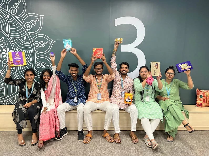 TTEC India team members holding up tokens of appreciation during Diwali celebration.