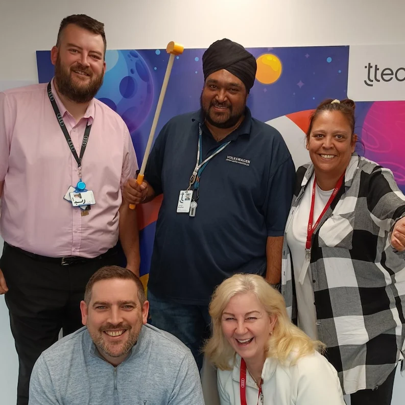 TTEC Leeds team members smiling for a picture.
