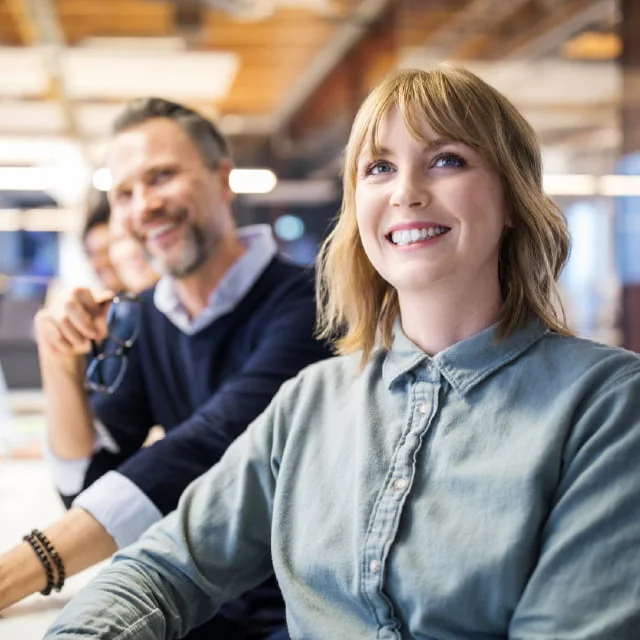 Group of employees working in open office environment