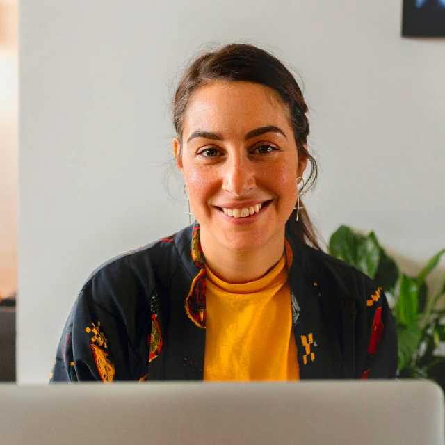 Woman working from home and smiling at the camera