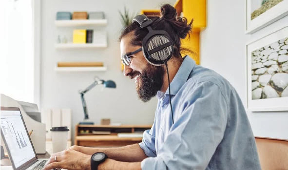 Man working in a home office wearing headphone