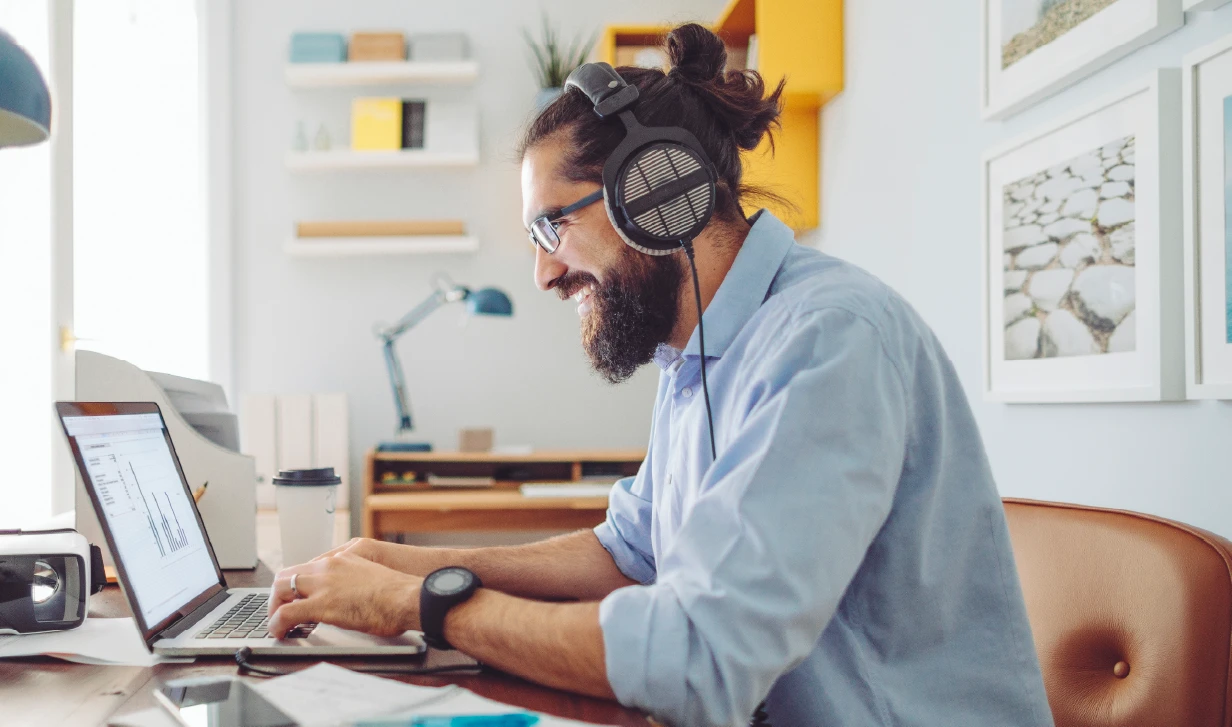 Man working in a home office wearing headphone