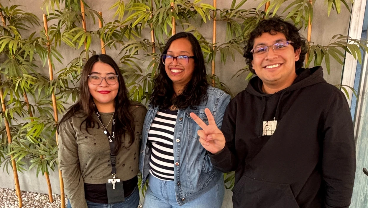 Three TTEC employees smiling.
