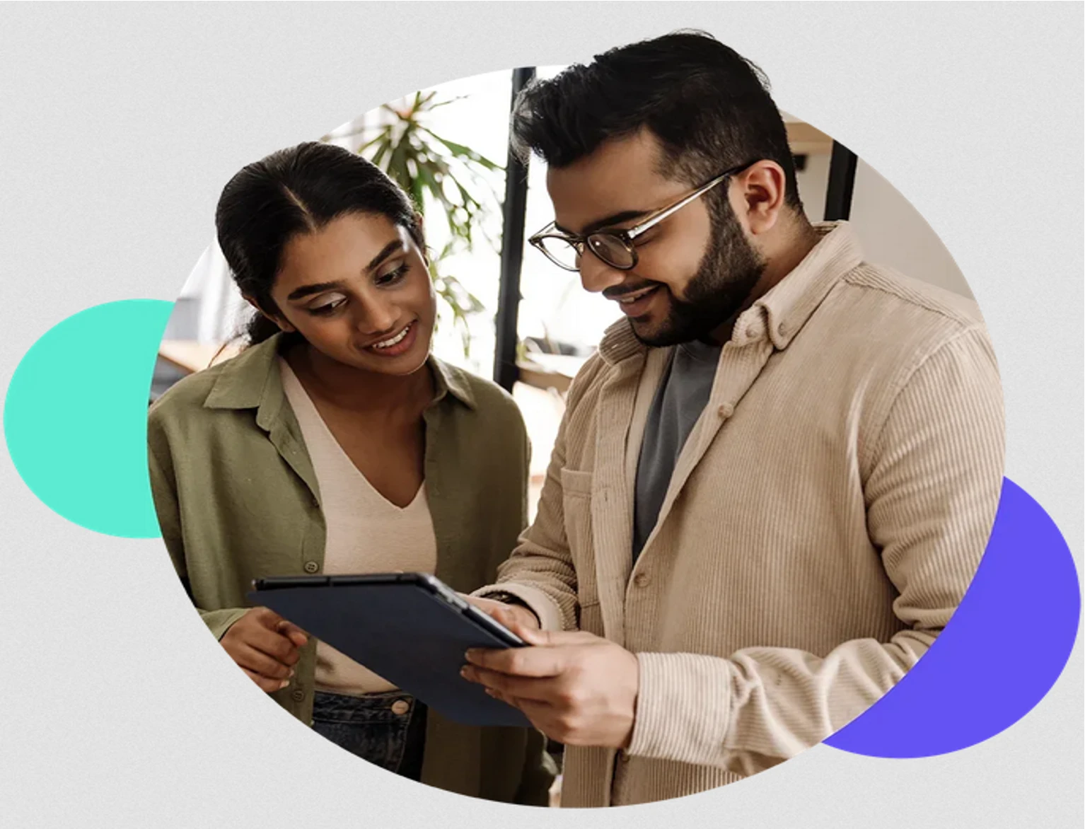 Two TTEC India team members reviewing content on a digital tablet
