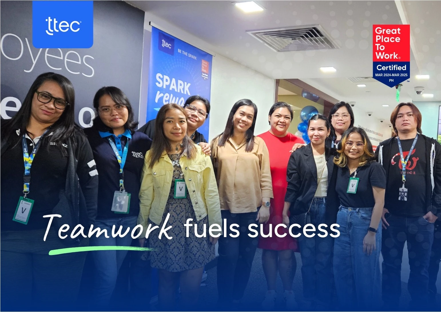 Group of TTEC employees standing together in office.