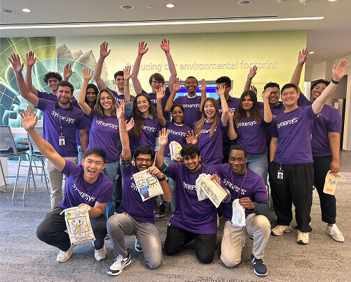 Group of employees with hands in the air