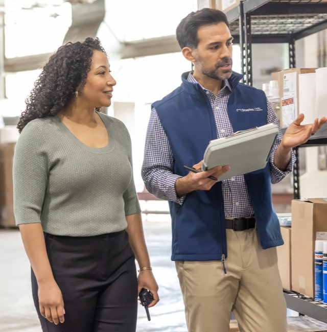 Woman and man in a warehouse looking at a shelf