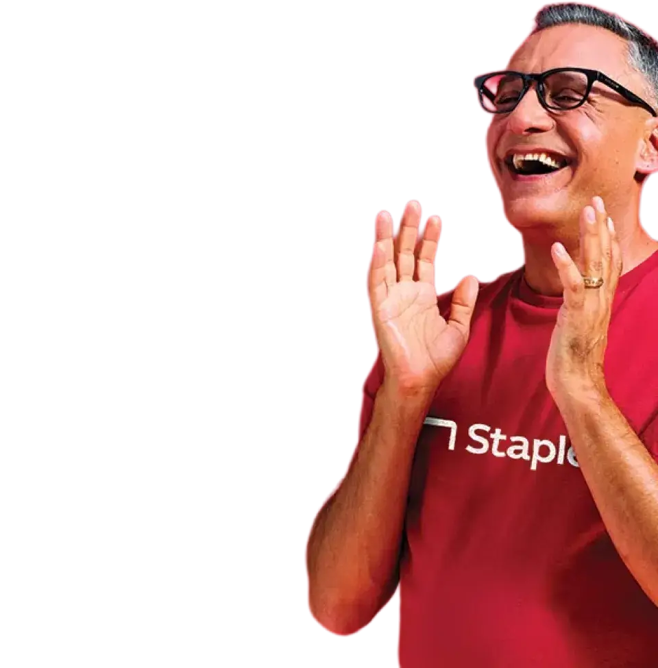 Man in Staples shirt smiling