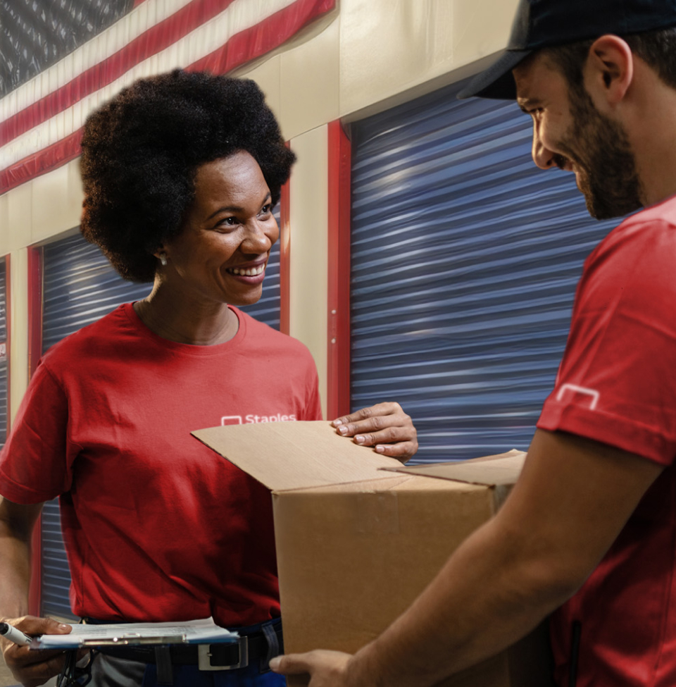 Staples employee in red shirt with box