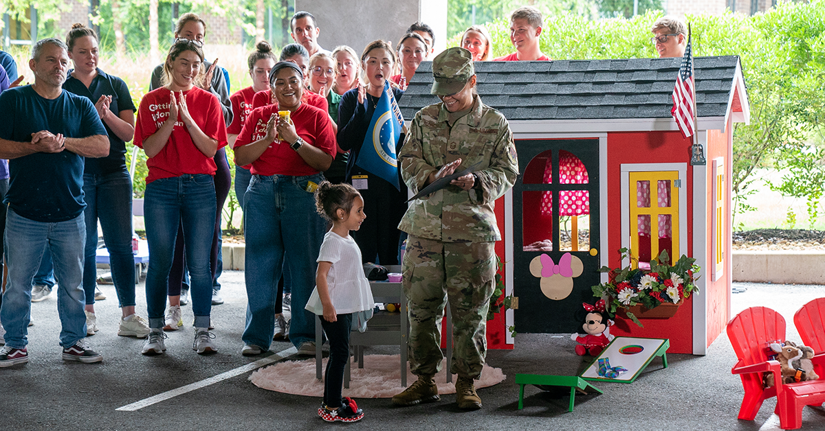 Army soldier in uniform with child playing