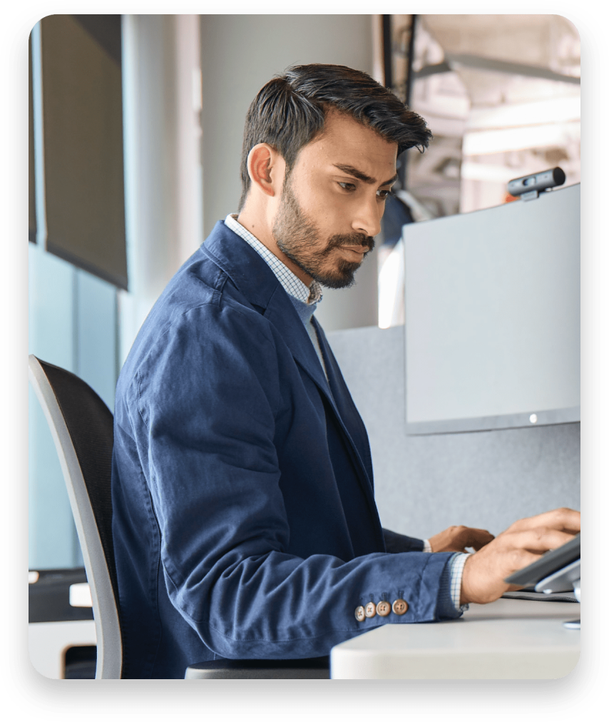 Man wearing headphones while working at his laptop.