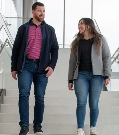 2 people walking and smiling