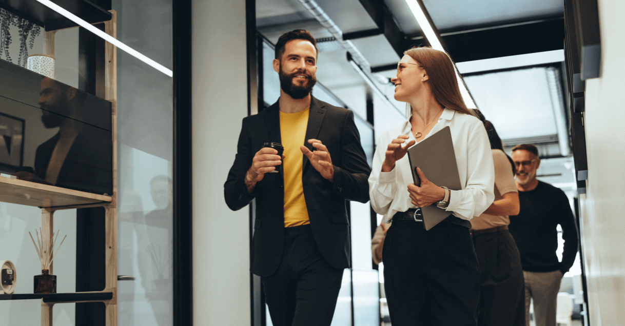 Group of business professionals walking down hallway