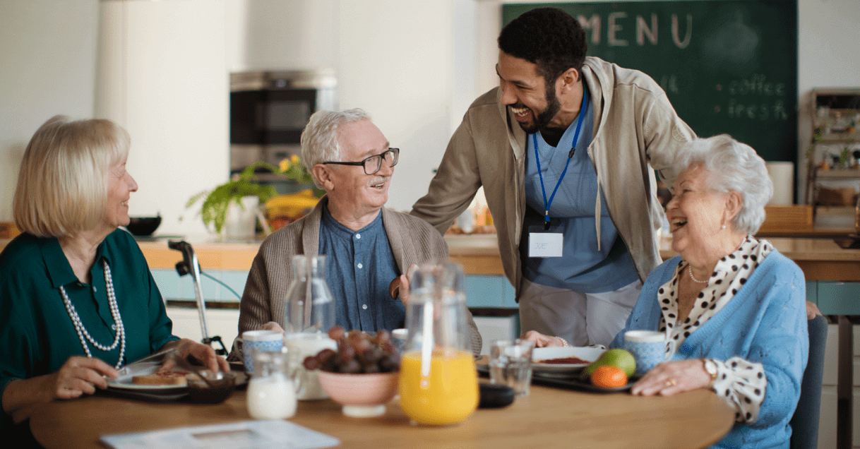 Ciena employee greeting residents eating breakfast